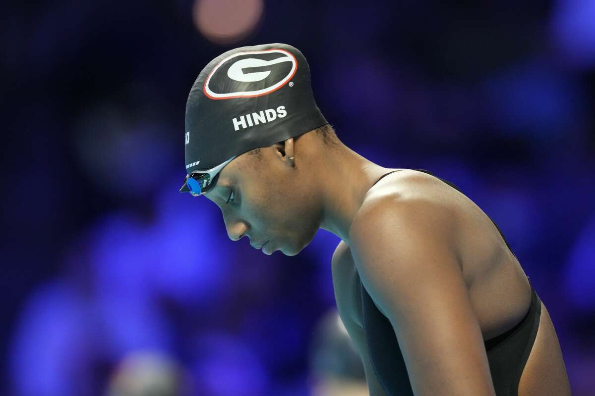 Natalie Hinds prepares to swim in a women's 100-meter freestyle prelim during wave 2 of the U.S. Olympic Swim Trials on Thursday, June 17, 2021, in Omaha, Neb. (AP Photo/Charlie Neibergall)