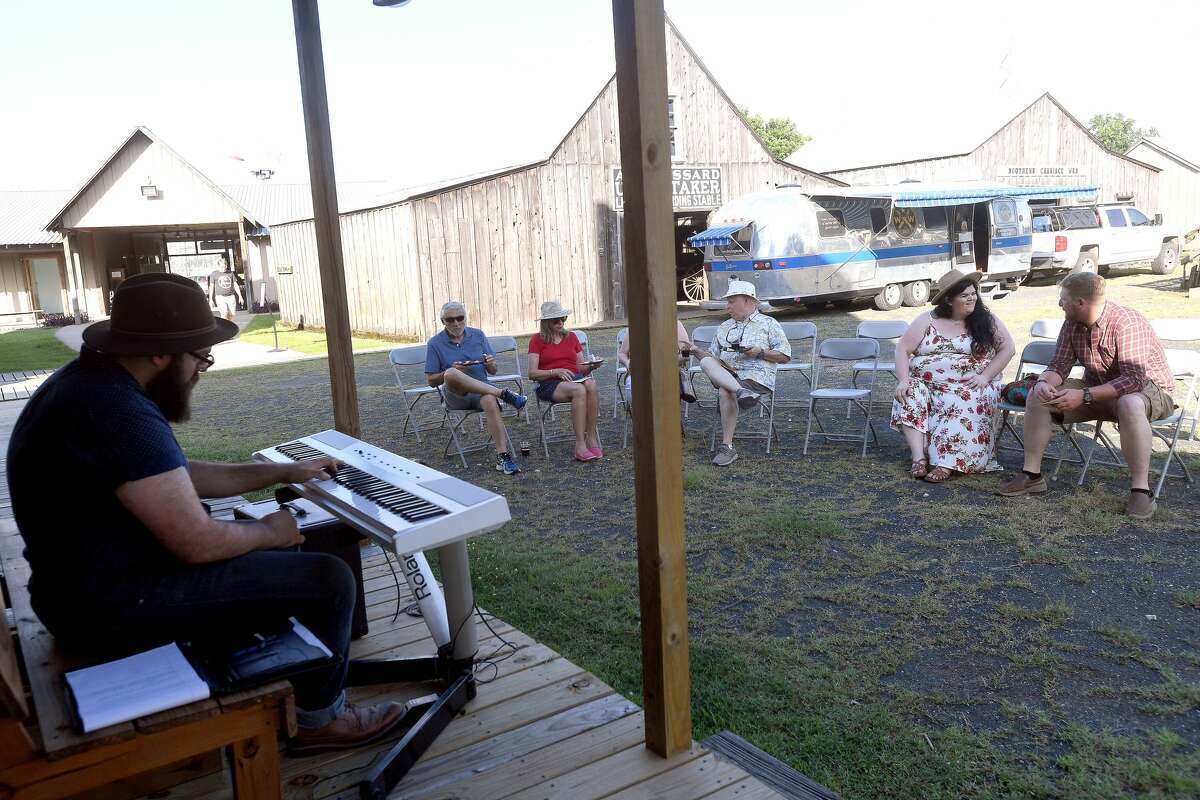 Seth Wade Melancon entertains on the saloon porch as guests enjoy a night of wine and jazz at the Spindletop-Gladys City Boomtown Museum Friday. Photo made Friday, June 18, 2021 Kim Brent/The Enterprise