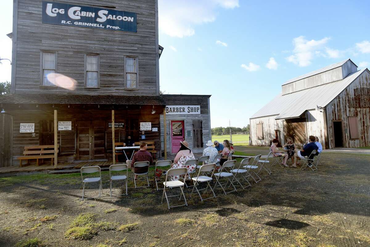 Friends socialize as Seth Wade Melancon performs while they enjoy a night of wine and jazz at the Spindletop-Gladys City Boomtown Museum Friday. Photo made Friday, June 18, 2021 Kim Brent/The Enterprise