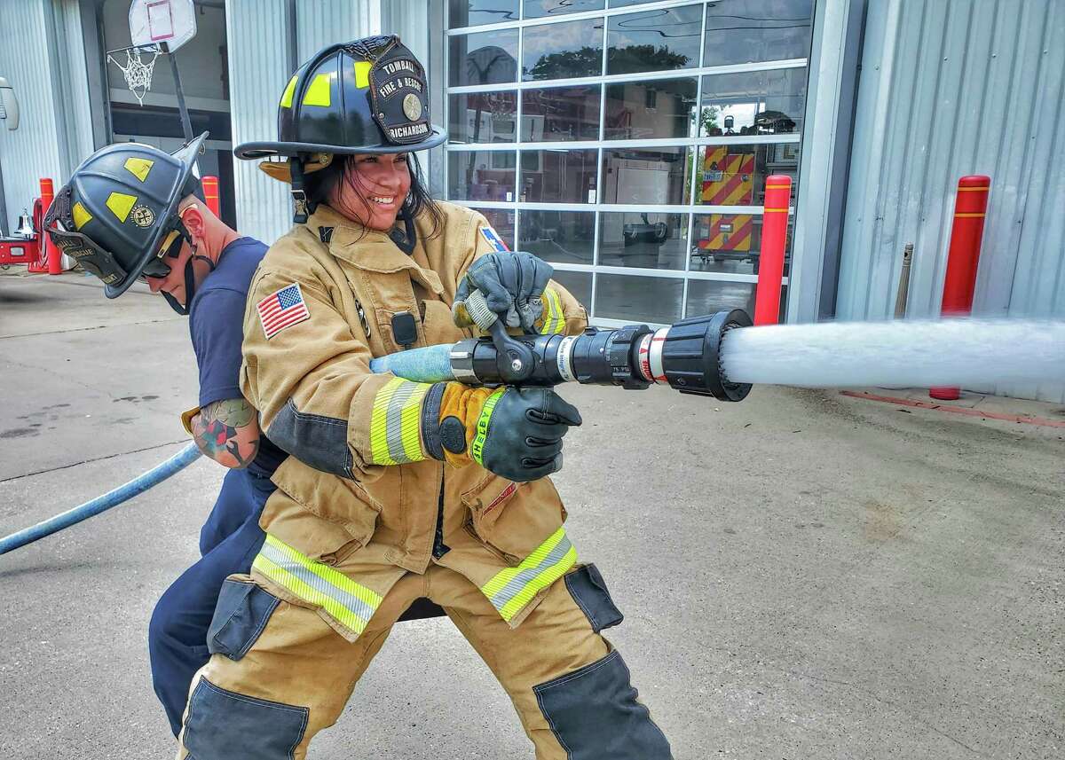 Alexis Reyes gets some backup while she maintains control of the fire hose during training at the Tomball Fire and Rescue. Reyes is interning at the department this summer as part of her training in preparation for a career in law enforcement at Sam Houston State University.