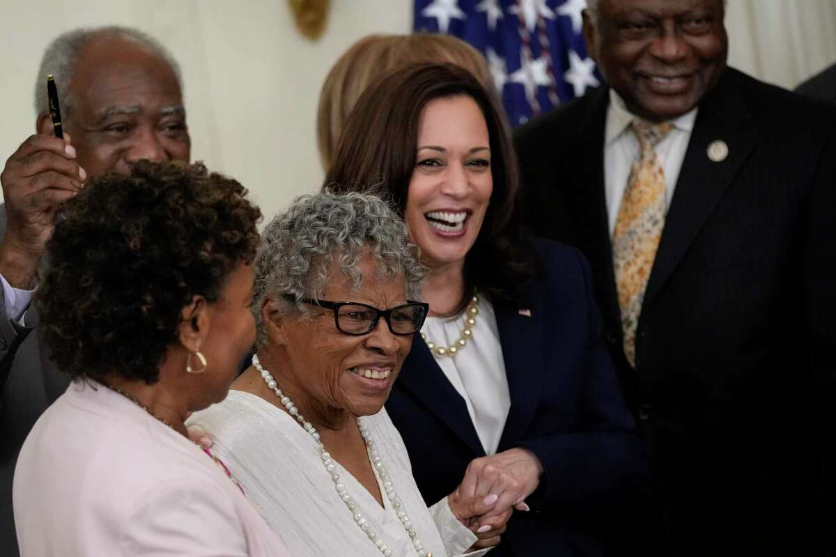 Opal Lee, a 94-year-old activist and retired educator, known as the Grandmother of Juneteenth, holds hands with Vice President Kamala Harris as President Joe Biden signs the Juneteenth National Independence Day Act into law on Thursday.