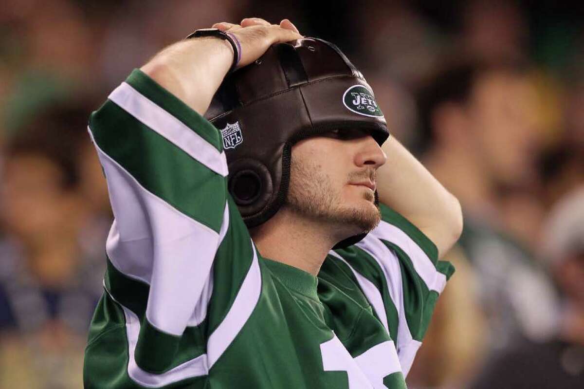 EAST RUTHERFORD, NJ - SEPTEMBER 13: A fan of the New York Jets reacts after a play against the Baltimore Ravens during their home opener at the New Meadowlands Stadium on September 13, 2010 in East Rutherford, New Jersey. (Photo by Jim McIsaac/Getty Images)