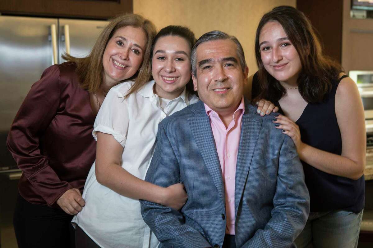 Heart transplant recipient Lucio Arreola poses for a portrait with wife, Elena De La Peña, far left, and his daughters, Lucia, 17, and Maria, 21, Tuesday, June 15, 2021 in Houston. Arreola is a recent heart transplant recipient who is living in Houston until he's well enough to travel back to Mexico City. Arreola worried about his new heart. Would it be the same as his native one? So he wrote a song with a music therapist about courage while he waited for a transplant, and his family joined him in the recording.