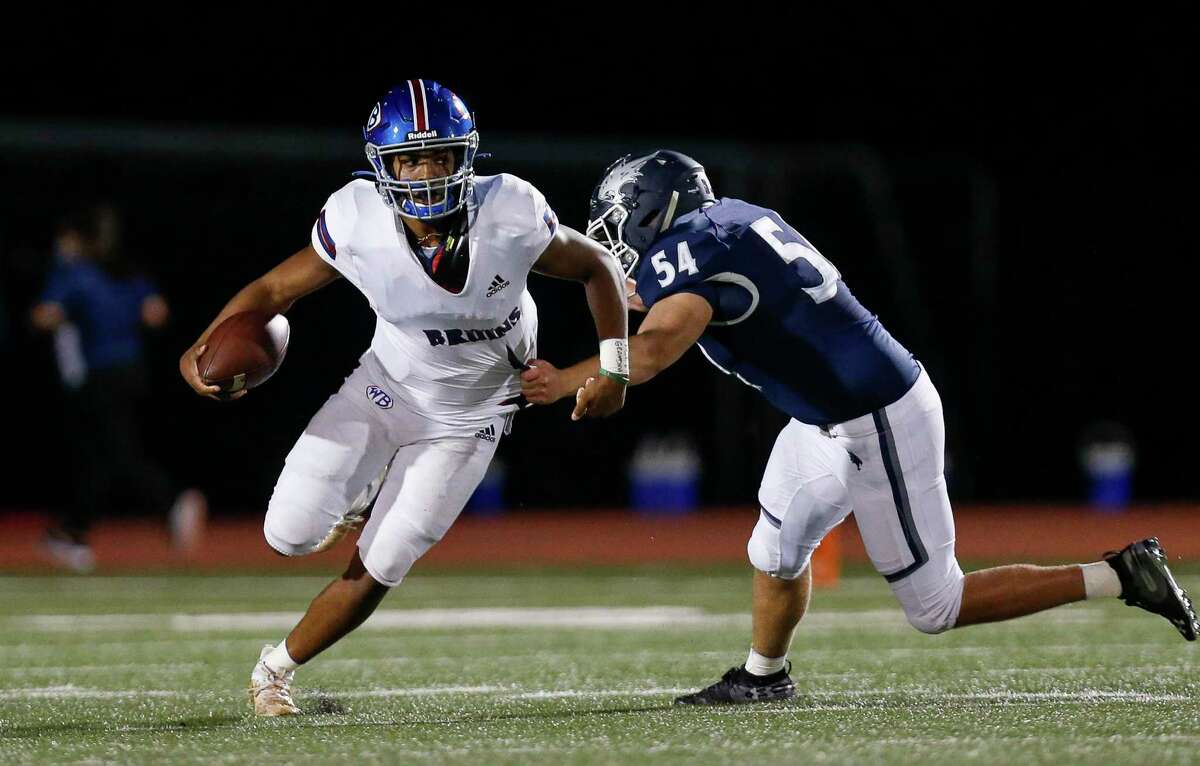 West Brook quarterback Bryce Anderson (1) gets away from Tomball Memorial defensive lineman Matthew Haban (54) during the first half of the game at Tomball ISD Stadium Friday, Oct. 2, 2020, in Tomball, Texas.