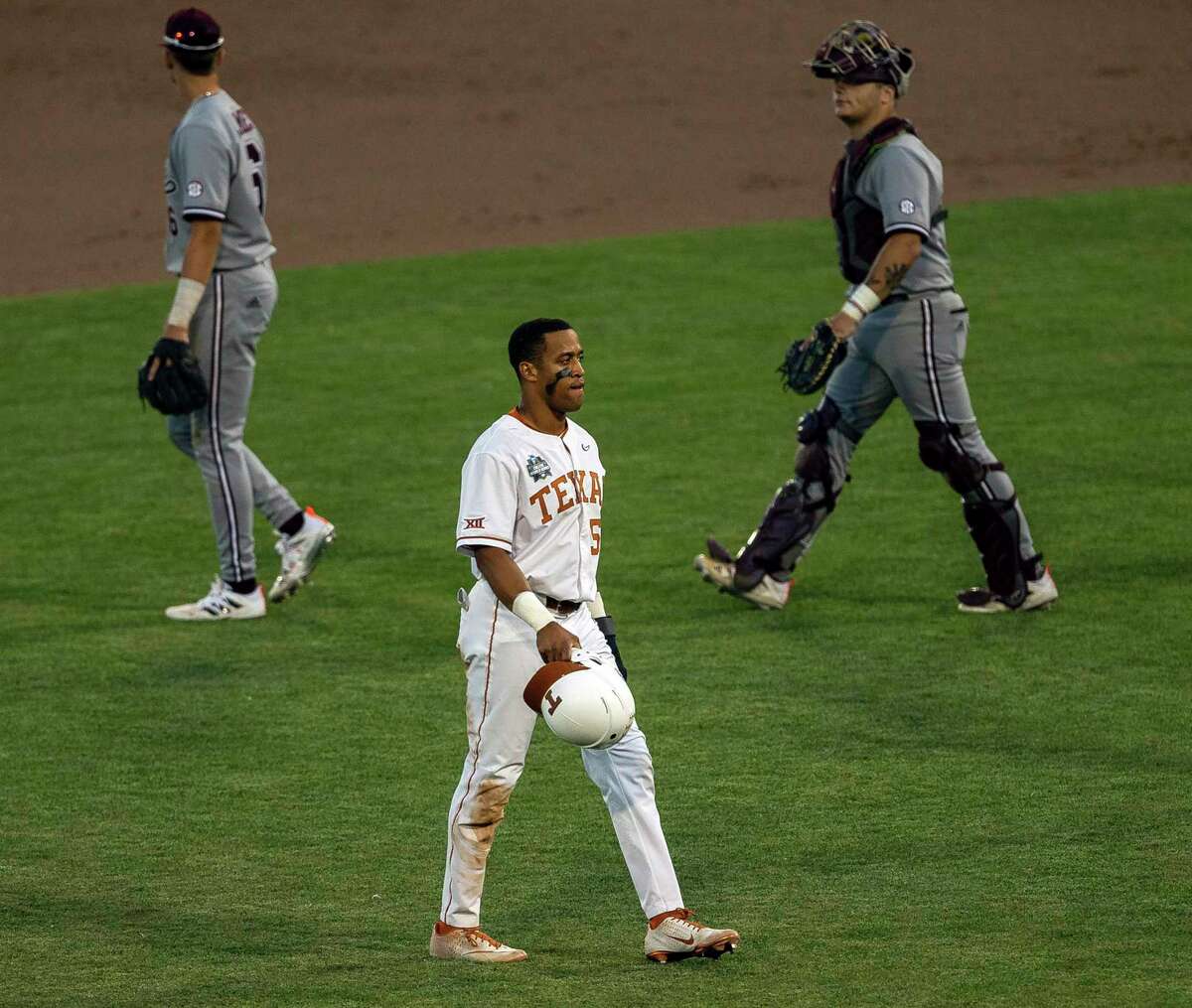 Texas' Camryn Williams (55) walks across the infield after the loss to Mississippi State in a baseball game in the College World Series, Sunday, June 20, 2021, at TD Ameritrade Park in Omaha, Neb. (AP Photo/John Peterson)