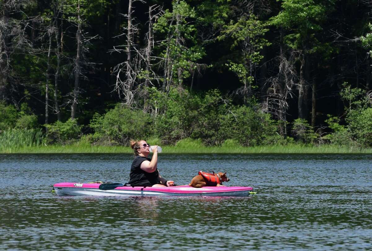 Shannon Simpson of Albany keeps hydrated as she kayaks on the lake with her dog Leo at Grafton Lakes State Park on Monday, June 21, 2021 in Grafton, N.Y. (Lori Van Buren/Times Union)