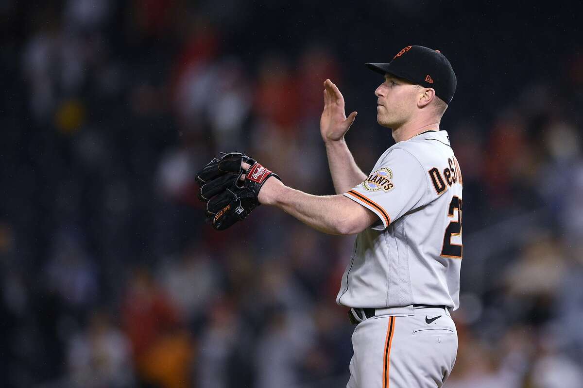 San Francisco Giants starting pitcher Anthony DeSclafani reacts after the tema's baseball game against the Washington Nationals, Friday, June 11, 2021, in Washington. The Giants won 1-0. (AP Photo/Nick Wass)