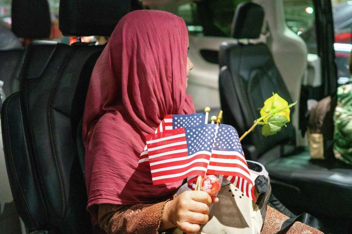 The family of an Afghan interpreter who was killed for working with the United States military arrives at George Bush Intercontinental Airport in Houston, June 12, 2021, greeted by volunteers with Combined Arms, a nonprofit serving veterans.
