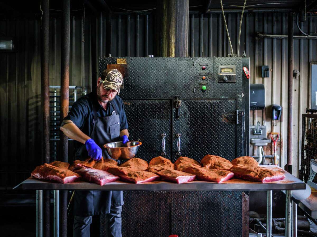 Pitmaster Jim Buchanan seasons signature meats at Dozier's BBQ in Fulshear which is now shipping its barbecue nationally through Williams-Sonoma.