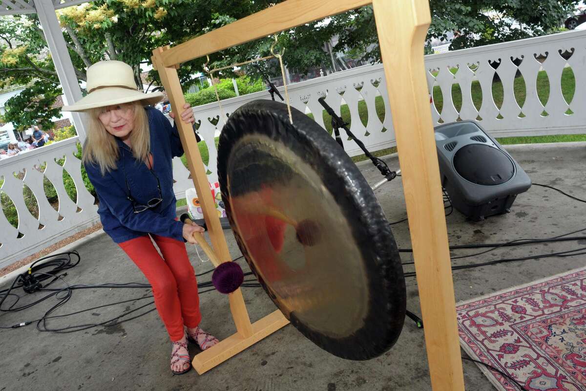 Husband and wife Chris Frantz and Tina Weymouth, of Fairfield, ring a set of gongs to kick off Make Music Day at the gazebo on Sherman Green, in Fairfield, Conn. June 21, 2021. Frantz and Weymouth are members of Talking Heads and Tom Tom Club. Make Music Day is an international festival marking the summer solstice.