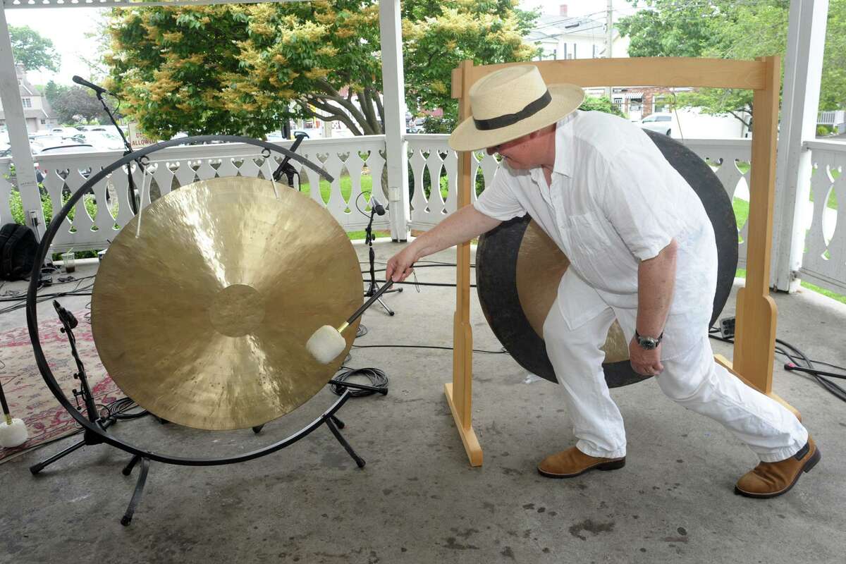 Husband and wife Chris Frantz and Tina Weymouth, of Fairfield, ring a set of gongs to kick off Make Music Day at the gazebo on Sherman Green, in Fairfield, Conn. June 21, 2021. Frantz and Weymouth are members of Talking Heads and Tom Tom Club. Make Music Day is an international festival marking the summer solstice.