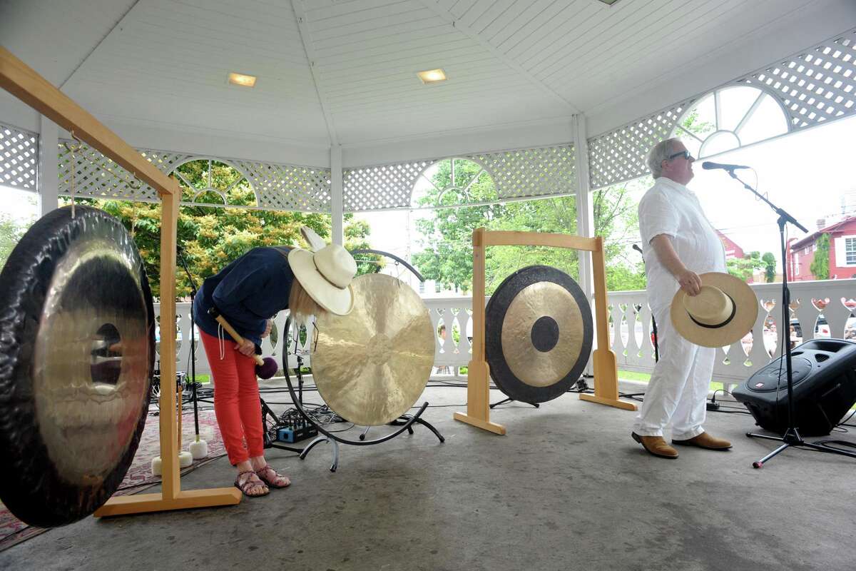Husband and wife Chris Frantz and Tina Weymouth, of Fairfield, ring a set of gongs to kick off Make Music Day at the gazebo on Sherman Green, in Fairfield, Conn. June 21, 2021. Frantz and Weymouth are members of Talking Heads and Tom Tom Club. Make Music Day is an international festival marking the summer solstice.