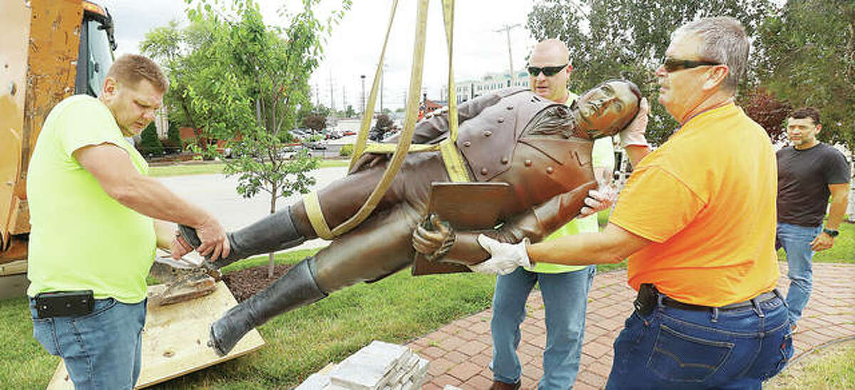 Edwardsville Public Works employees swing the controversial statue of Ninian Edwards around after cutting it loose from its pedestal in June. The statue is a focal point for the Our Edwardsville movement that rallied against the likeness of first territorial governor in the early 1800s because he owned slaves and supported genocide against indigenous populations.