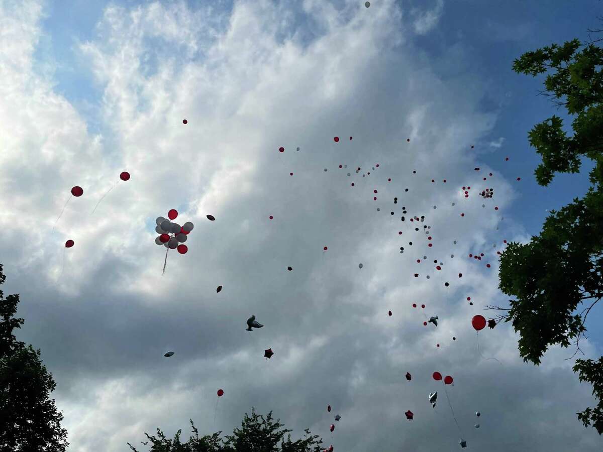 DANBURY, Conn. — Balloons rise over the Joseph Sauer Memorial Park on Beaver Street during a memorial service for Yhameek Johnson on Monday, June 21, 2021. Police said the 18-year-old was killed in a drive by shooting the night before.