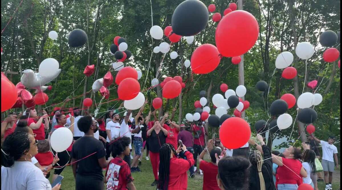 Balloons rise over the Joseph Sauer Memorial Park on Beaver Street during a memorial service for Yhameek Johnson on Monday, June 21, 2021. Police said the 18-year-old was killed in a drive by shooting the night before.