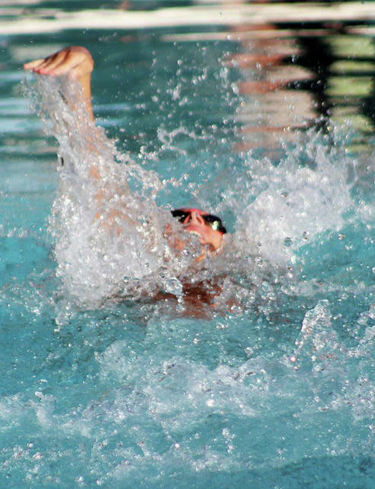 Savannah Grinter of Montclaire does a leg of the 15-18 girls backstroke relay Monday at the SWiSA Relays at Sunset Hills.