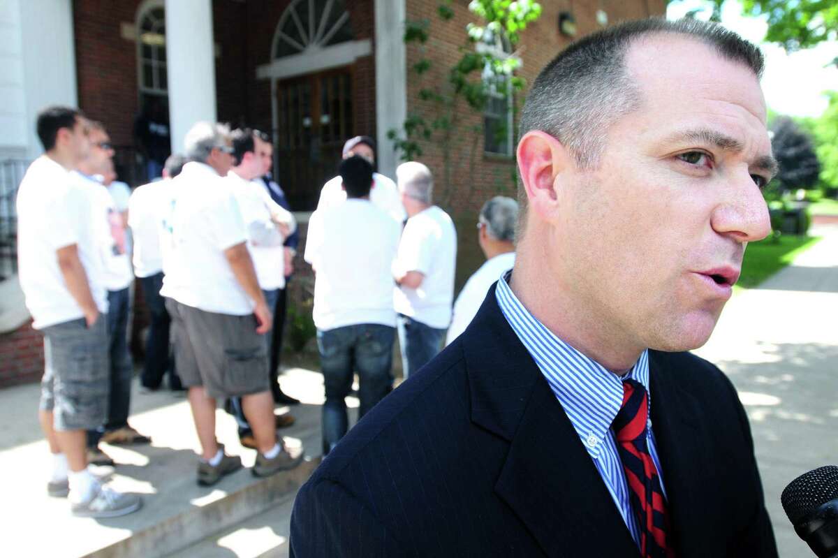 State's Attorney Kevin Lawlor (right) speaks to the press outside of Superior Court in Milford on 6/6/2011 after the arraignment of Bobby Kinnebrew for his part in the fatal shooting of West Haven Post Road Deli clerk Mohamed Bilal Altinawi on 5/9/2011. Photo by Arnold Gold/New Haven Register AG0413E