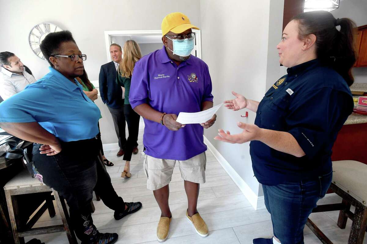Mayor Thurman Bartie talks with GLO's Rhonda Masters (left) and Brittany Eck as he arrives at Pebble Creek Apartments in Port Arthur for a ribbon cutting and celebration of the final damage repairs that were made after Harvey using money from the GLO's disaster recovery assistance program. $16 million in grants were made available for multi-family dwelling repairs or new construction. Thirteen such units in Jefferson County - at least 5 of which were located in Port Arthur - benefitted from the program. Photo made Wednesday, June 16, 2021 Kim Brent/The Enterprise