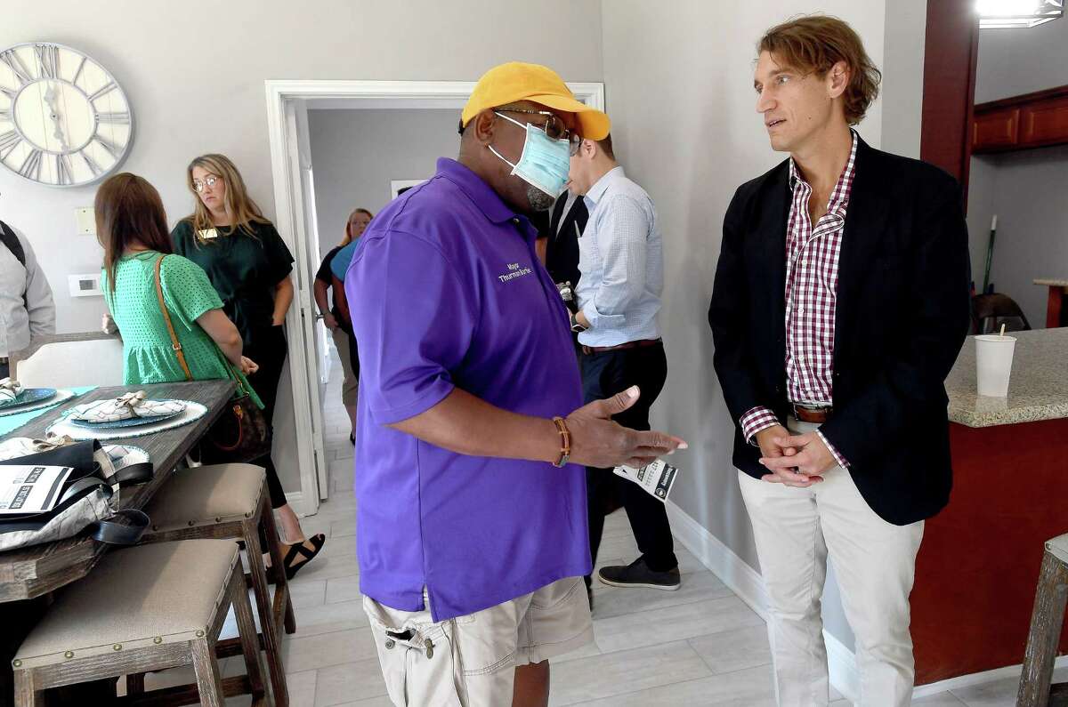 Chris Akbari, CEO of ITEX talks with Mayor Thurman Bartie as members of the GLO, ITEX - the property management company for Pebble Creek Apartments in Port Arthur - and others gathered at the complex for a ribbon cutting and celebration of the final repairs that were made after Harvey using money from the GLO's disaster recovery assistance program. $16 million in grants were made available for multi-family dwelling repairs or new construction. Thirteen such units in Jefferson County - at least 5 of which were located in Port Arthur - benefitted from the program. Photo made Wednesday, June 16, 2021 Kim Brent/The Enterprise