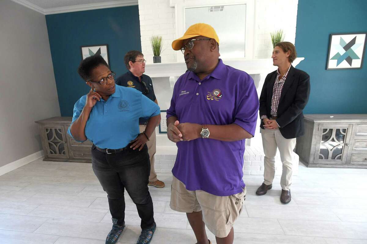 GLO's Rhonda Masters talks with Mayor Thurman Bartie after members of the GLO, ITEX - the property management company for Pebble Creek Apartments in Port Arthur - and Mayor Thurman Bartie gathered at the complex for a ribbon cutting and celebration of the final repairs that were made after Harvey using money from the GLO's disaster recovery assistance program. $16 million in grants were made available for multi-family dwelling repairs or new construction. Thirteen such units in Jefferson County - at least 5 of which were located in Port Arthur - benefitted from the program. Photo made Wednesday, June 16, 2021 Kim Brent/The Enterprise