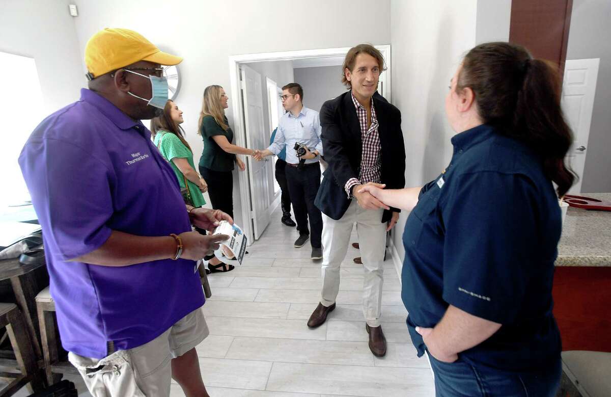 Chris Akbari, CEO of ITEX greets GLO's Brittany Eck, and Mayor Thurman Bartie as embers of the GLO, ITEX - the property management company for Pebble Creek Apartments in Port Arthur - and others gathered at the complex for a ribbon cutting and celebration of the final repairs that were made after Harvey using money from the GLO's disaster recovery assistance program. $16 million in grants were made available for multi-family dwelling repairs or new construction. Thirteen such units in Jefferson County - at least 5 of which were located in Port Arthur - benefitted from the program. Photo made Wednesday, June 16, 2021 Kim Brent/The Enterprise