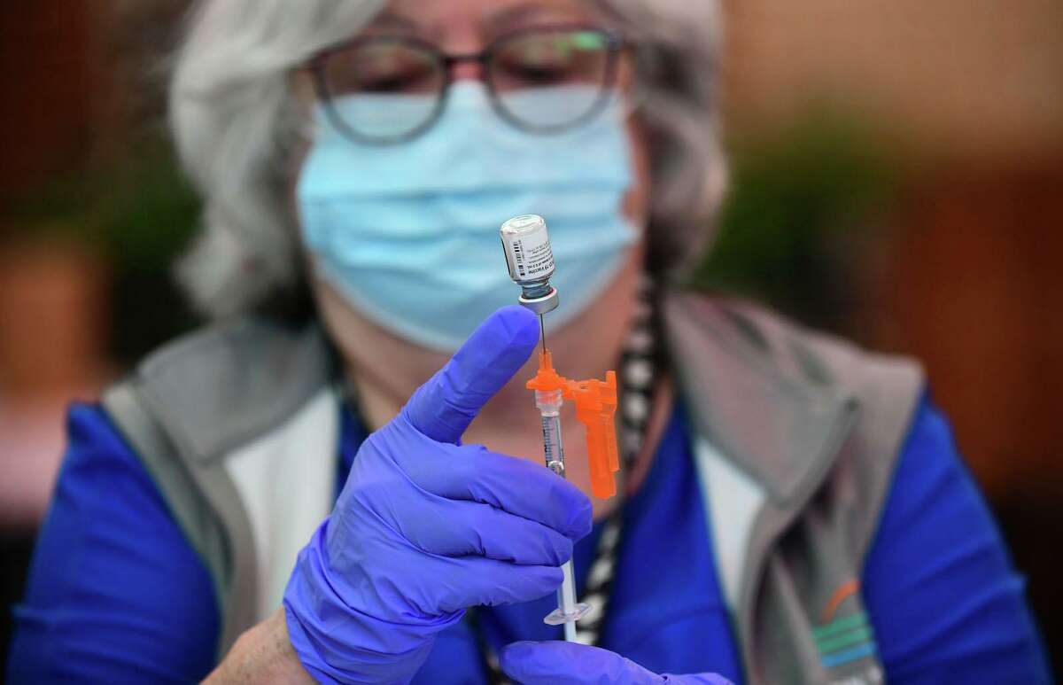 A Griffin Hospital nurse prepares to administer a COVID-19 vaccine in June 2021 at Stew Leonard’s in Norwalk, Conn. Registered nurses remain among the jobs most in demand in Connecticut, with more than 4,000 openings in July according to The Conference Board.