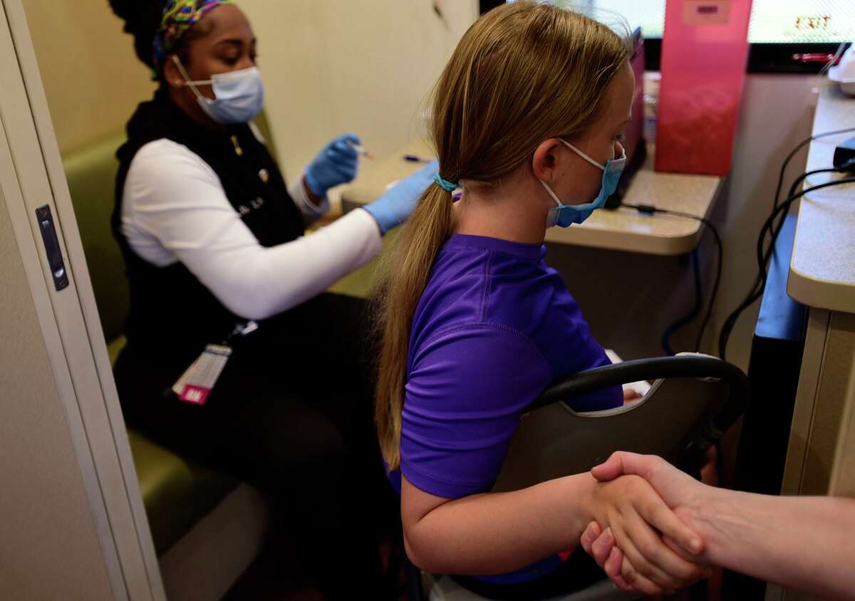 Students including Ann Taylor get vaccinated at the Norwalk Public Schools COVID vaccine clinic Thursday, May 20, 2021, in the Norwalk Community Health Center mobile unit at West Rocks Elementary School in Norwalk, Conn.