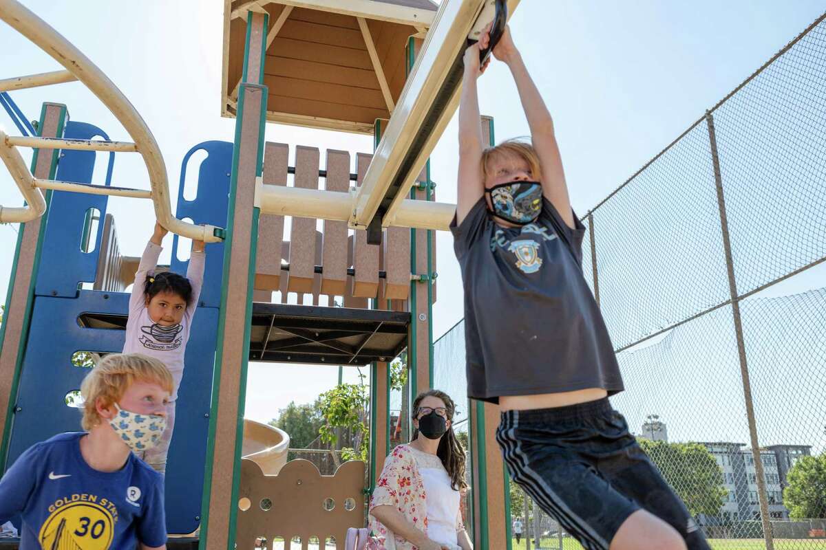 Ellis Barringhaus (left) and companions enjoy the playground at Jackson Park in San Francisco. Cases of COVID-19 among children have risen in S.F. and across California in recent weeks.