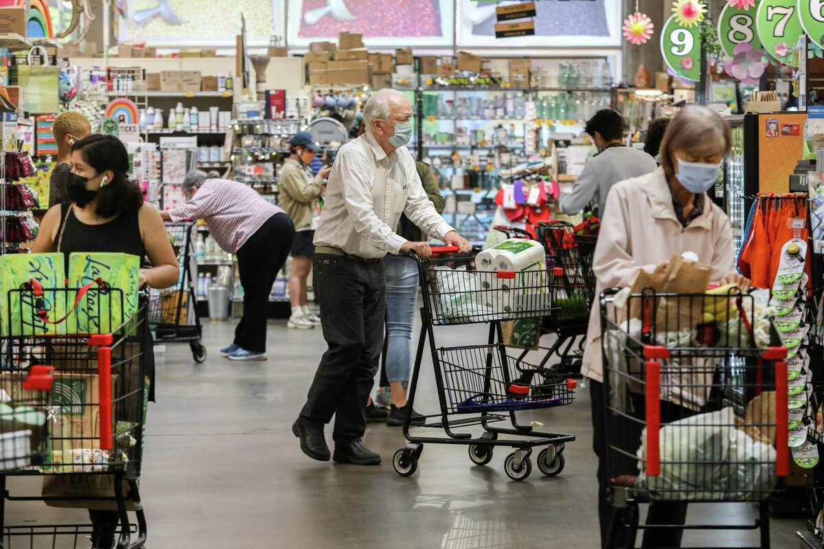 Masked shoppers browse for groceries at Rainbow Grocery in San Francisco in June. In Yolo County, authorities have recommended that both vaccinated and unvaccinated people wear masks indoors due to the spread of the highly contagious delta variant.