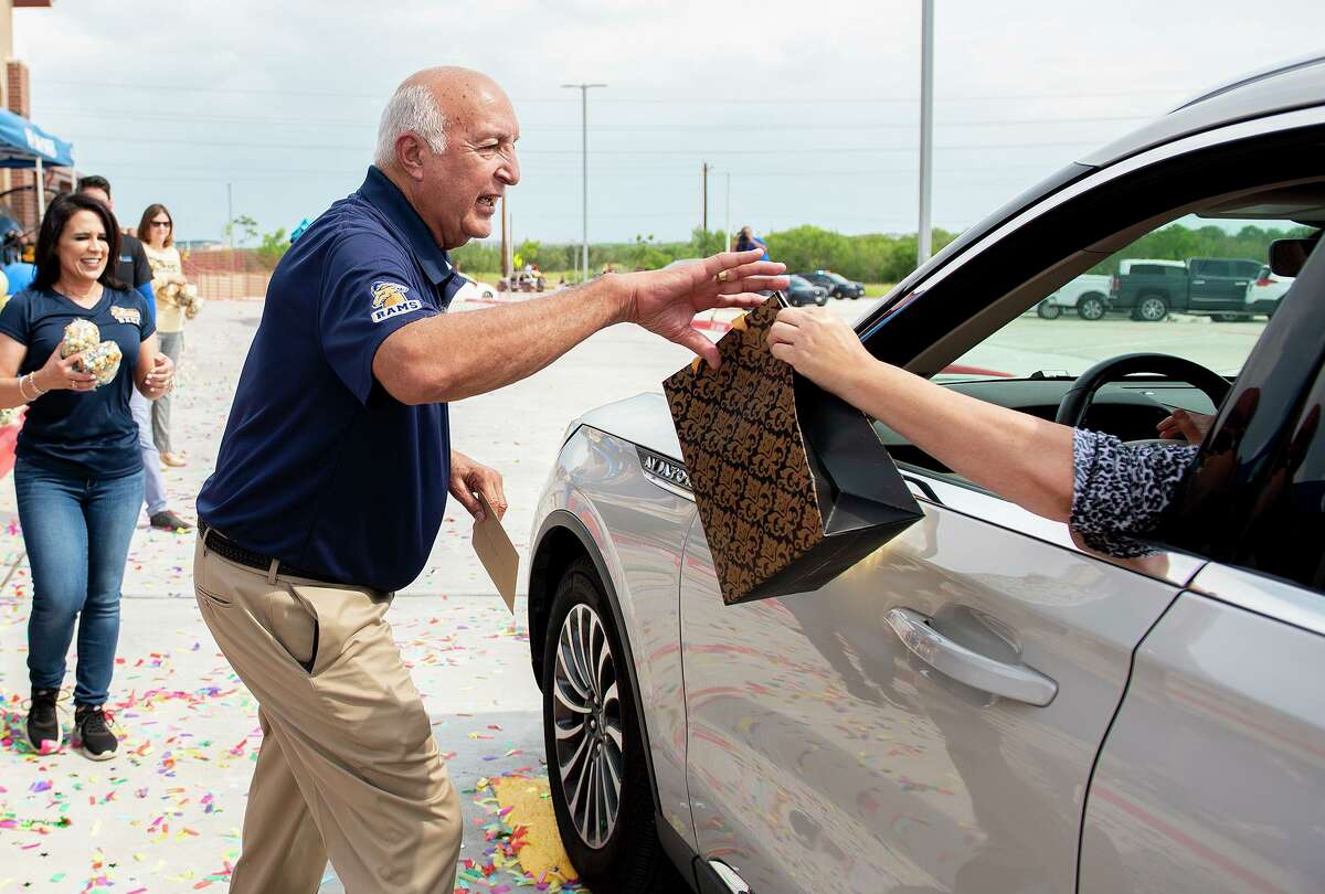 Retiring UISD Superintendent Roberto J. Santos receives gifts from well-wishers, Tuesday, June 22, 2021, at Roberto. J Santos Elementary School during parade celebrating Santos' career and retirement.