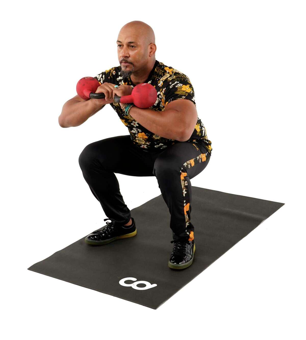 Lower your hips into a squat, keeping your torso erect. Press through your heels at the bottom of the squat., and return to the top position.