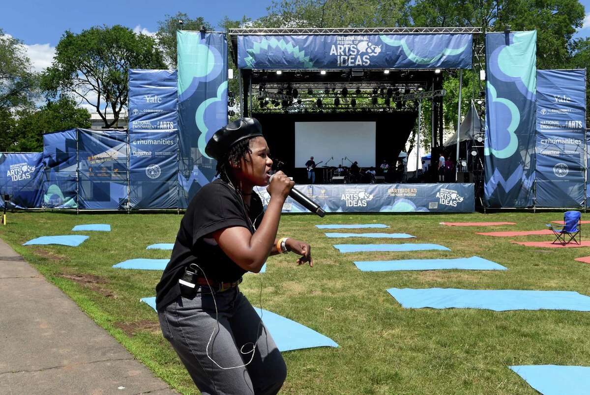 New Haven singer Thabisa Rich, who was born and raised in South Africa, does a sound check while rehearsing on the New Haven Green before an International Festival of Arts & Ideas performance later that night on June 23, 2021.