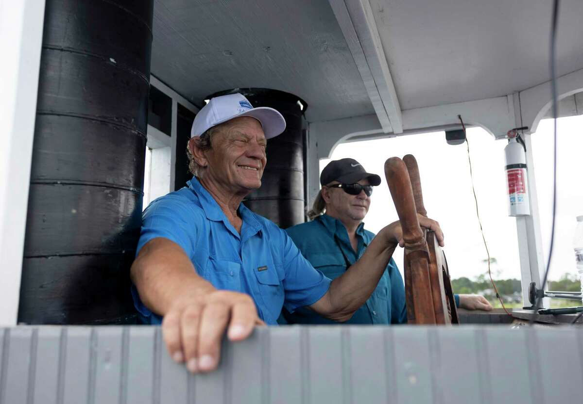 Captain Dale Shaver, left, and Trevor Hill steer the Lake Conroe Queen during the launch of the paddleboat style vessel, Wednesday, June 23, 2021, in Conroe. The Lake Conroe Queen was built in 1986 in Grand Ledge, Michigan and has traveled to Indiana, Colorado and Louisiana.