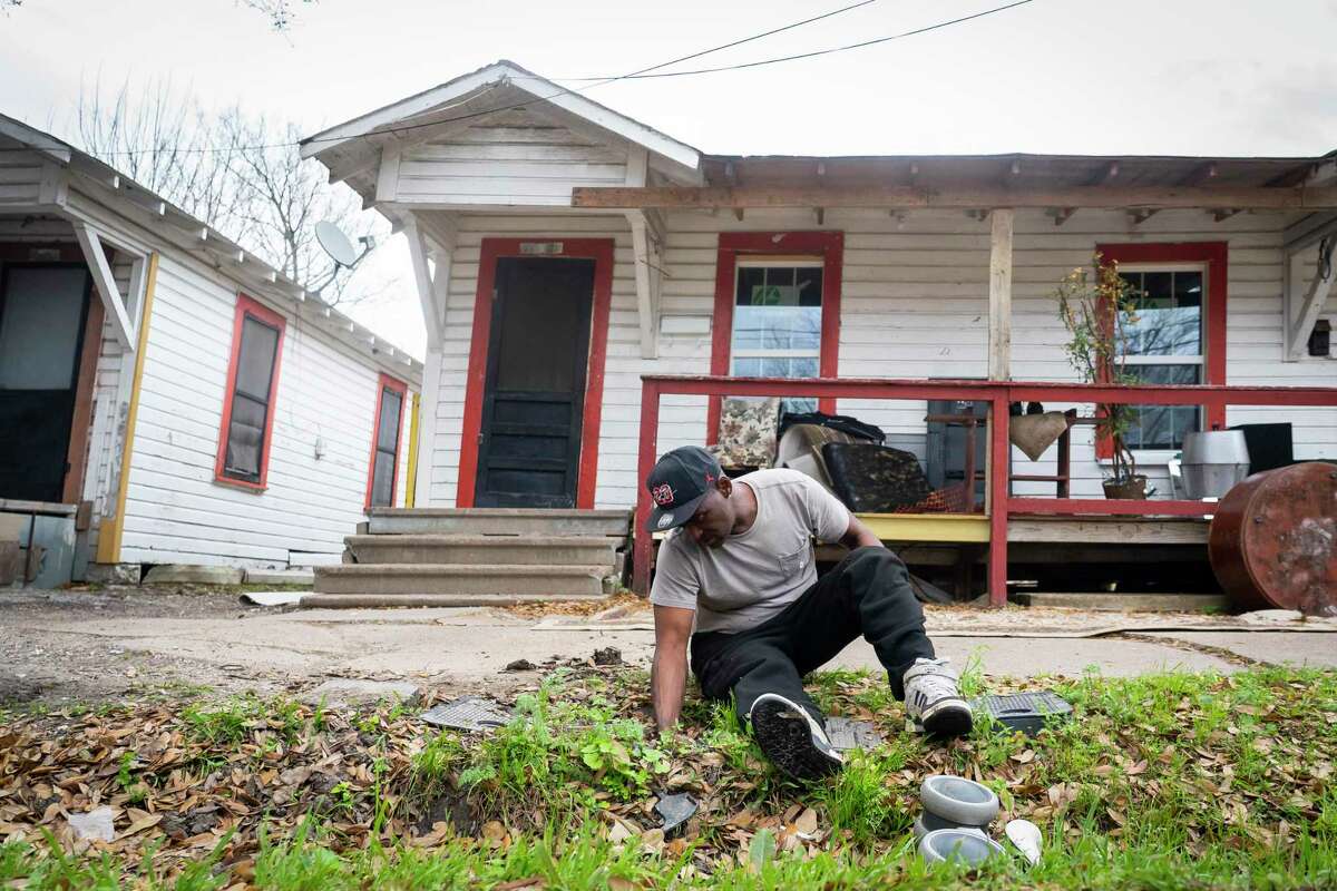 Norris Williams shuts off the water to his home in Fifth Ward on Wednesday, March 10, 2021, in Houston. Burst pipes along a row of four rental houses on the street had left Williams' family without running water since the freeze in February.