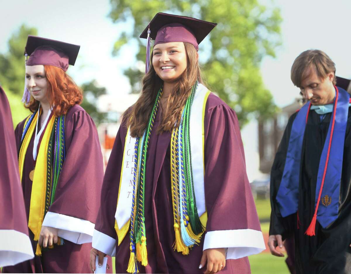 Valedictorian Audrey Keener, left, and class Vice President Ashlynn Ehrhard march near the front of the procession into the Bethel High School graduation ceremony at the school in Bethel, Conn. on Wednesday, June 23, 2021.