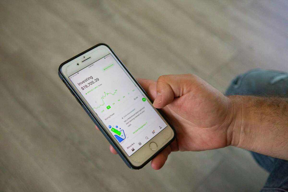 Shay Kornfeld holds out his phone to show the Robinhood app he uses to make small investments. Shay, who lives in Walnut Creek, was an early inventor in Dogecoin. His 2018 investment of $500 eventually became $30,000, this past May. He hopes to take out the money once a year to spend on family trips and experiences.