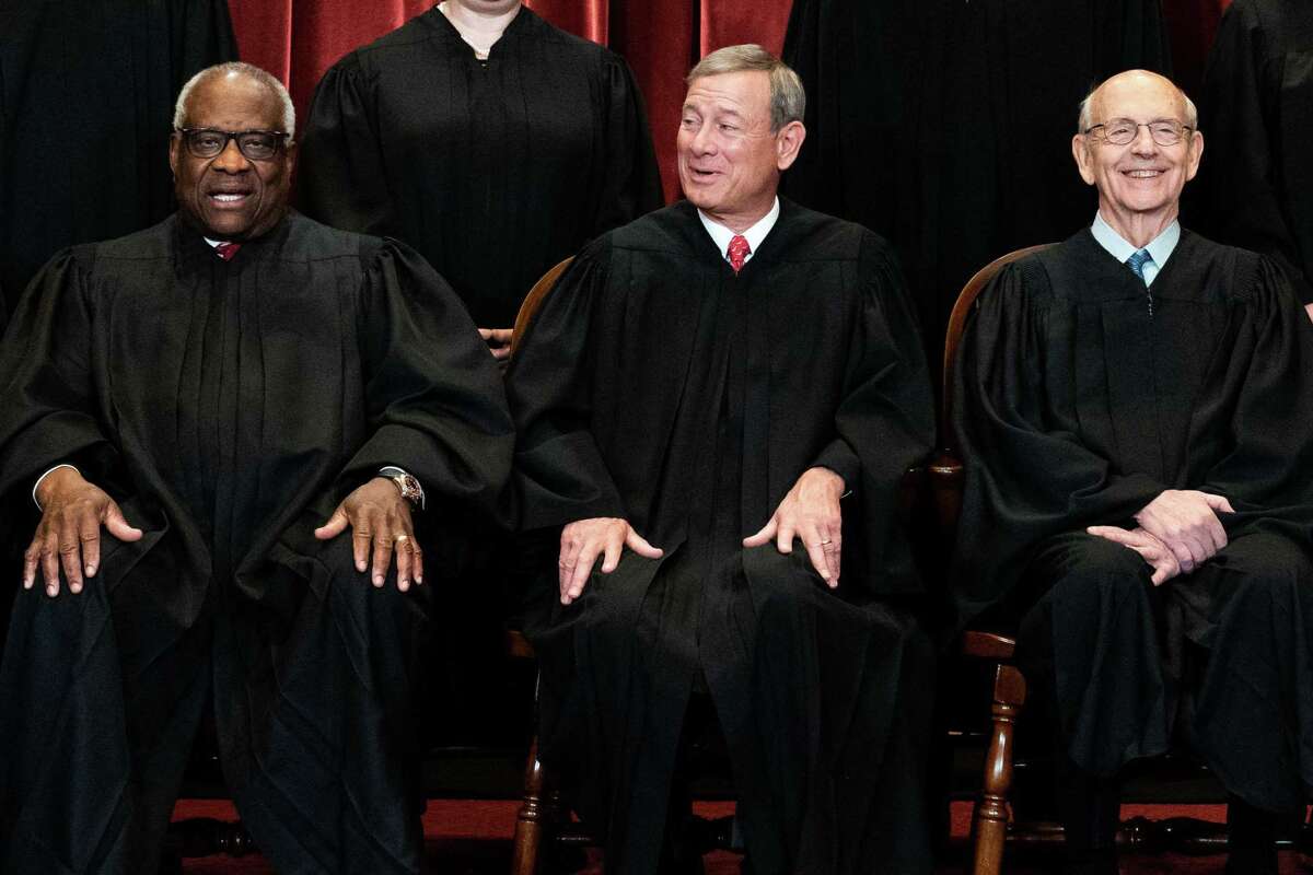 (FILES) In this file photo members of the Supreme Court pose for a group photo at the Supreme Court in Washington, DC on April 23, 2021, seated (L-R) Associate Justice Clarence Thomas, Chief Justice John Roberts and Associate Justice Stephen Breyer. - Pressure on US Chief Justice Stephen Breyer to retire is growing: progressive Democrats are anxiously eyeing his seat, Republicans have laid down the gauntlet, and issues from abortion to voting rights could all be at stake. Top Senate Republican Mitch McConnell turned up the heat on June 14, 2021 when he said his party would block anyone nominated to Supreme Court by Democratic President Joe Biden if Republicans regain control of the Senate in the 2022 midterm elections. (Photo by Erin SCHAFF / POOL / AFP) (Photo by ERIN SCHAFF/POOL/AFP via Getty Images)