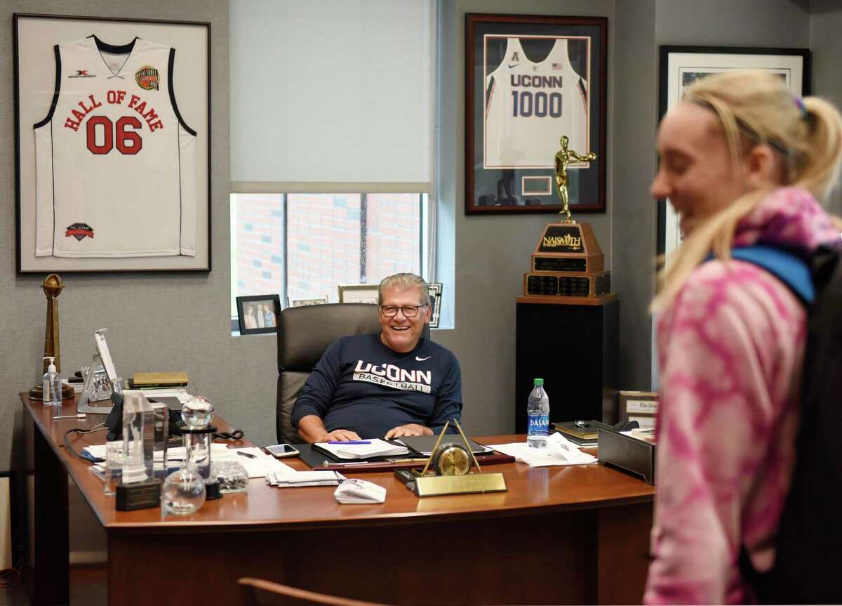 UConn women's basketball coach Geno Auriemma chats with sophomore guards Nika Mühl, not pictured, and Paige Bueckers in his office at the Werth Family UConn Basketball Champions Center on the UConn main campus in Storrs, Conn. Monday, June 14, 2021.