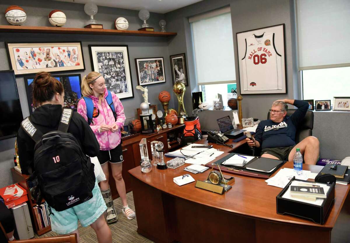 UConn women's basketball coach Geno Auriemma chats with sophomore guards Nika Mühl, left, and Paige Bueckers in his office at the Werth Family UConn Basketball Champions Center on the UConn main campus in Storrs, Conn. Monday, June 14, 2021.