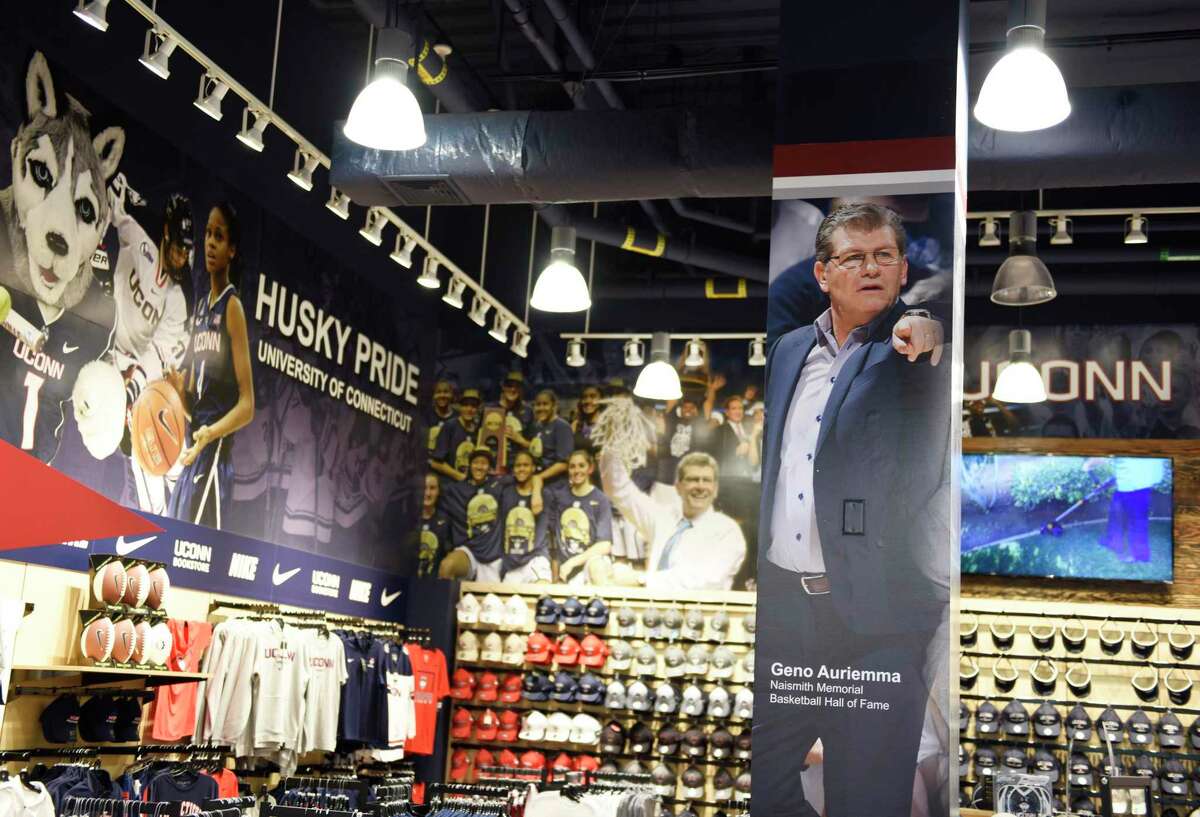 A photo of men's basketball coach Geno Auriemma is displayed among Huskies basketball apparel in the UConn Bookstore on the UConn main campus in Storrs, Conn., photographed on Wednesday, June 9, 2021.