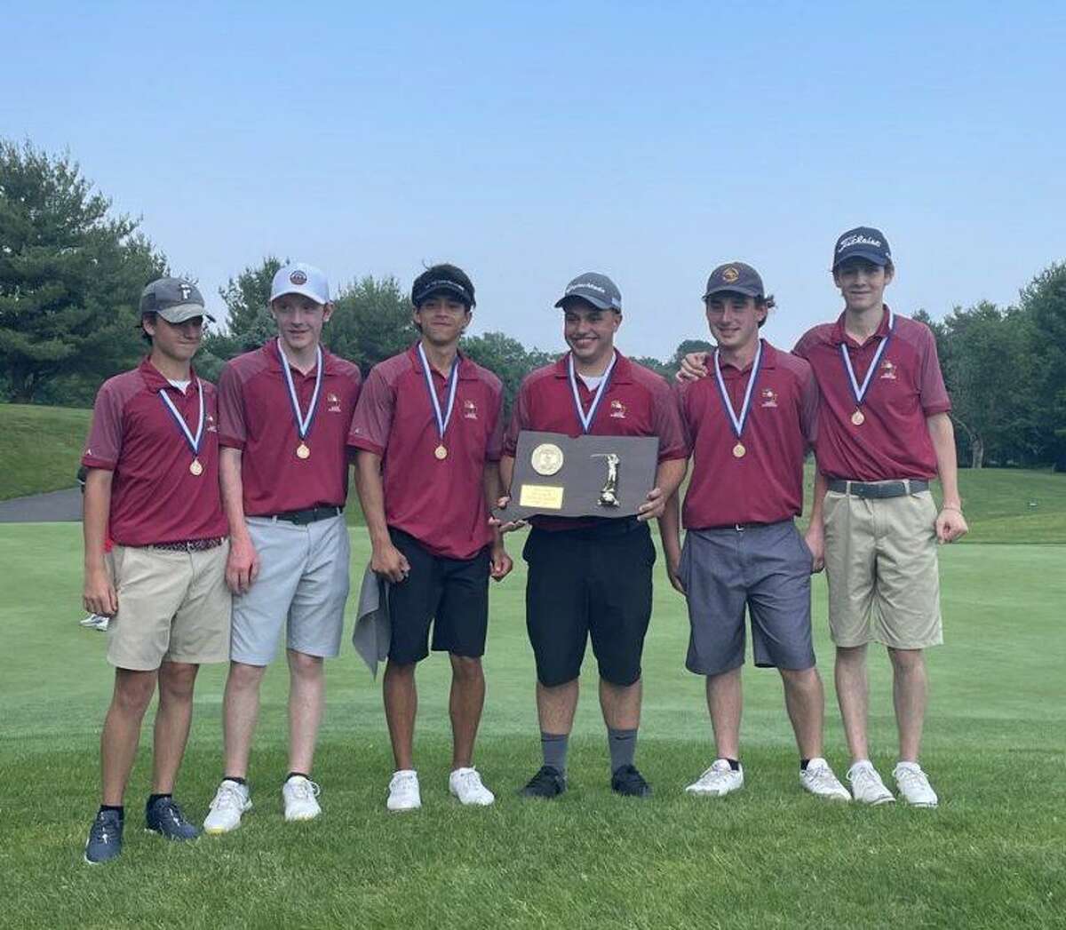 St. Joseph golf team members Andrew Flynn, Colin Firda, Luke Fortin, Billy Lesko, Anthony Jacozzi and Robbie Sluga stand with the CIAC Division III championship plaque.