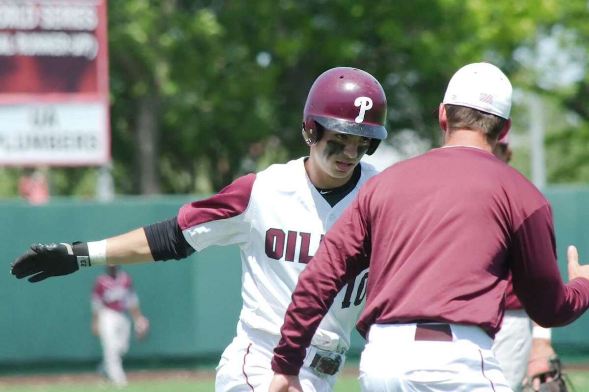 Pearland's Connor Wong is congratulated by former Oiler head coach Anthony Scalise after hitting a home run against Clear Creek.