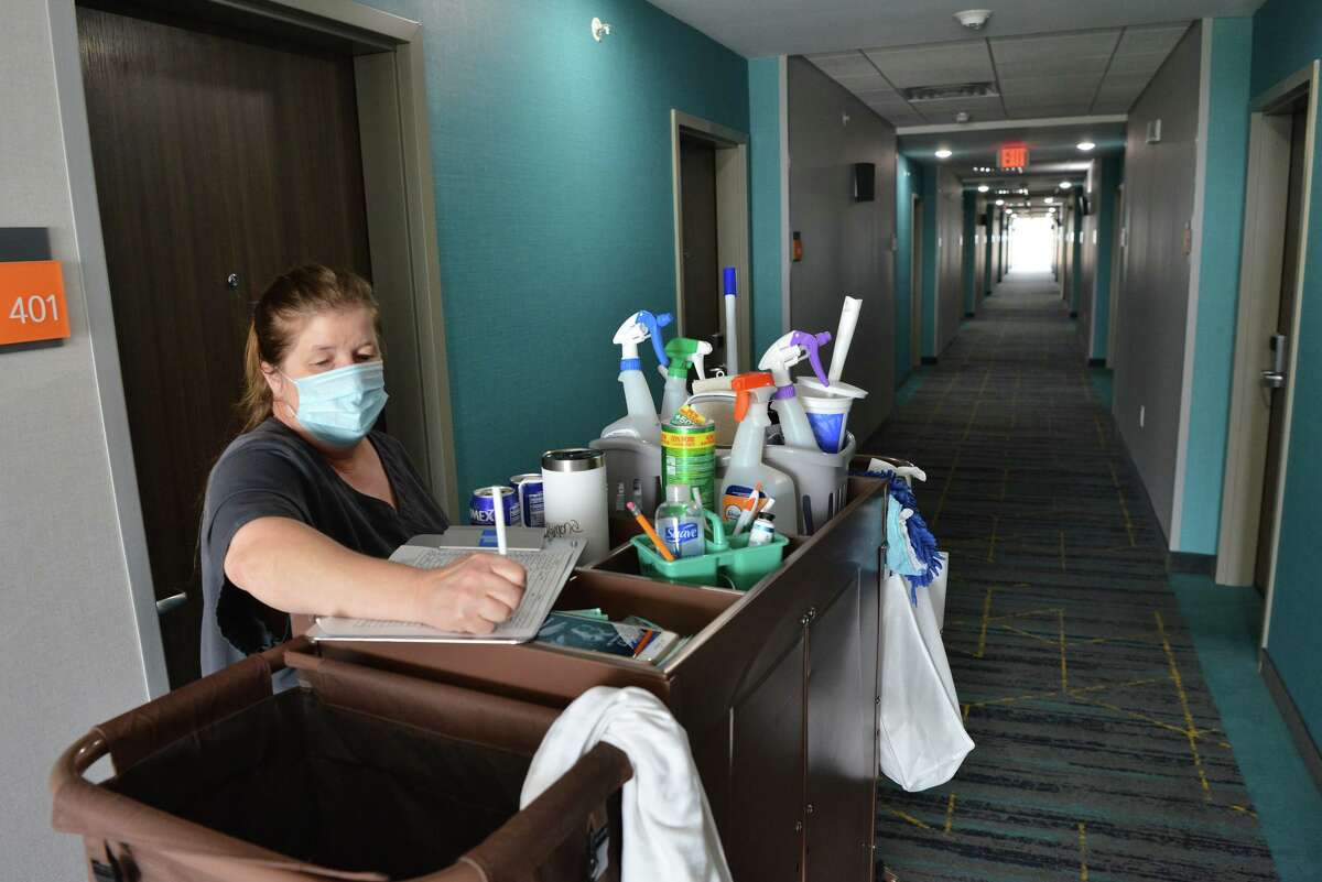Ramona Ward of the housekeeping staff at the LaQuinta Inn, 11006 N I-35, does paperwork as the area's lodging sector begins to rebound from the pandemic.