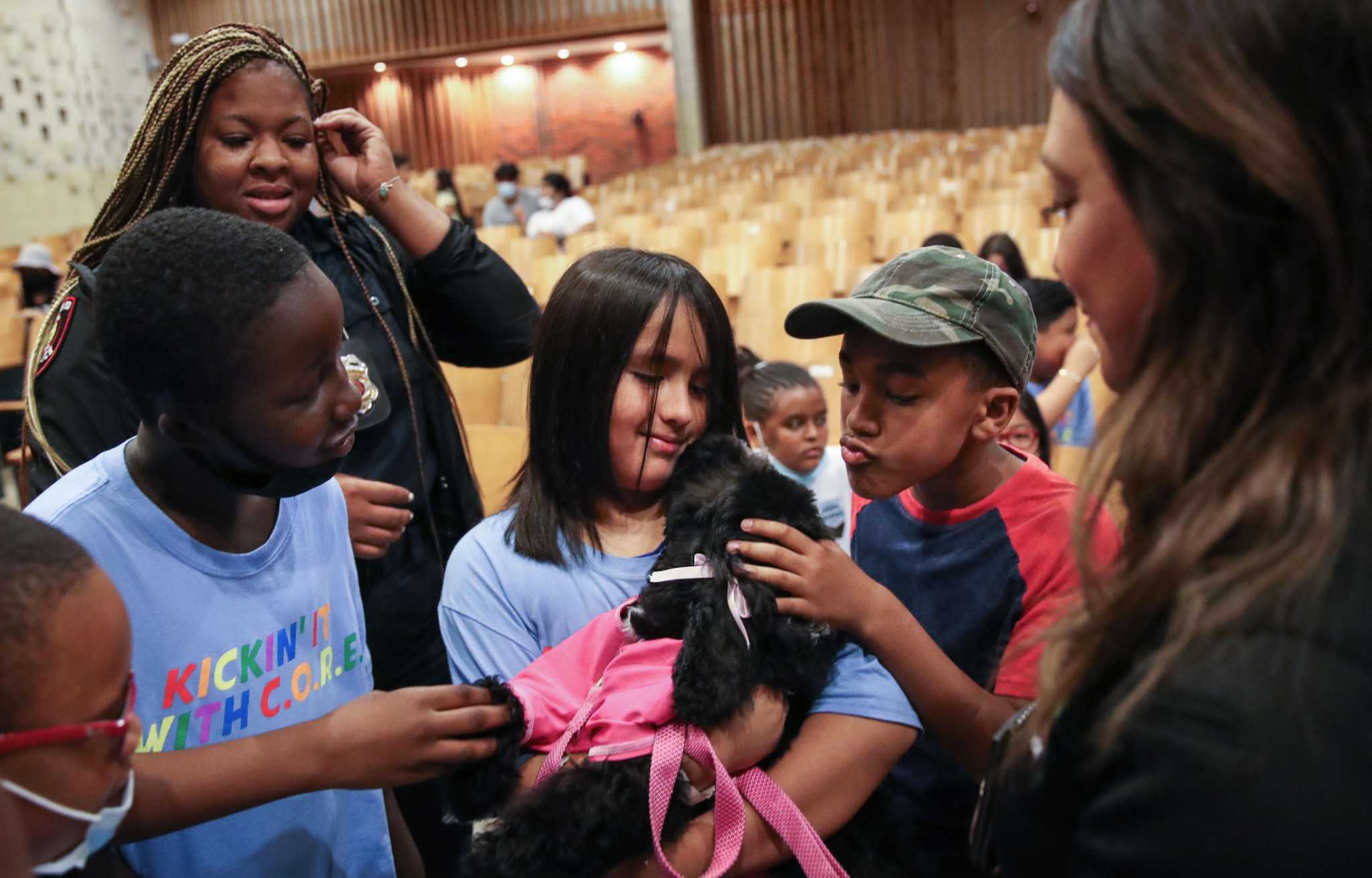 Jamaica, the new HISD police emotional support dog, meets kids at