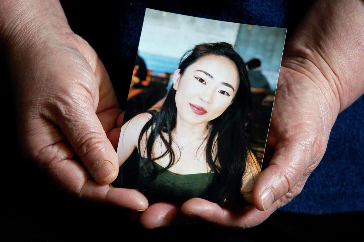 Hiroko Abe holds a photo of her daughter Hanako Abe, in San Francisco, Calif. Hanako, 27, was killed in the New Years Eve hit-and-run crash. Abe’s parents are readying a wrongful death lawsuit against the city, claiming her death was preventable, but for the actions of law enforcement.