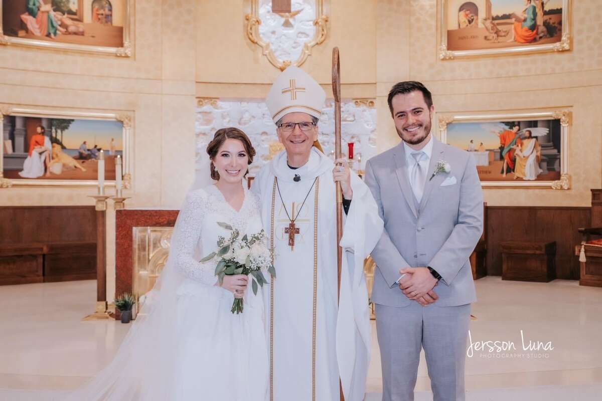 Mariana and her husband with Archbishop Gustavo Garcia-Siller.