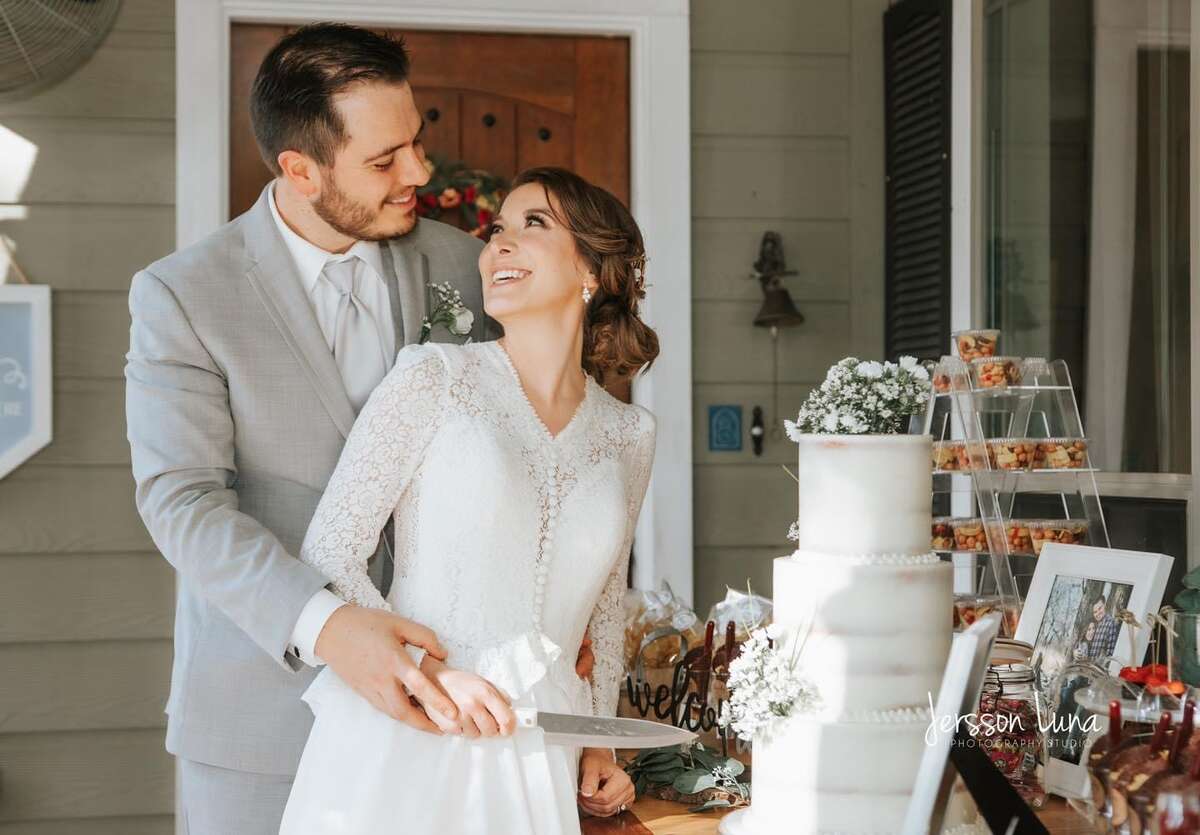 The couple cuts their wedding cake. 