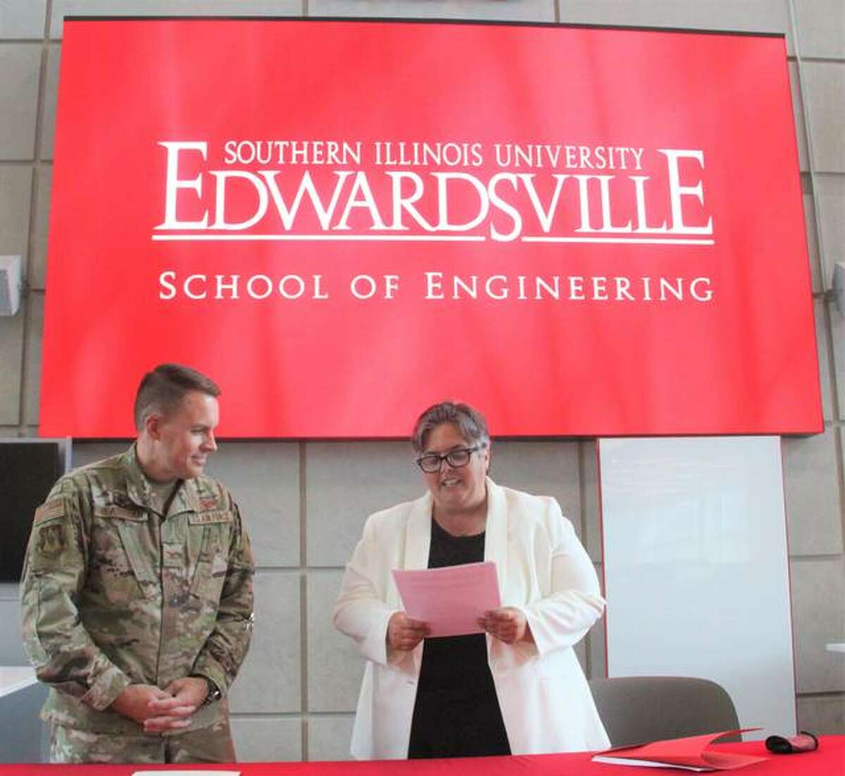 Col. J. Scot Heathman, commander of the 375th Air Mobility Wing at Scott Air Force Base in Belleville, and .SIUE Provost and Vice Chancellor for Academic Affairs Denise Cobb talk before signing a three-year educational agreement between the university and the unit’s “innovation hub” called Elevate.