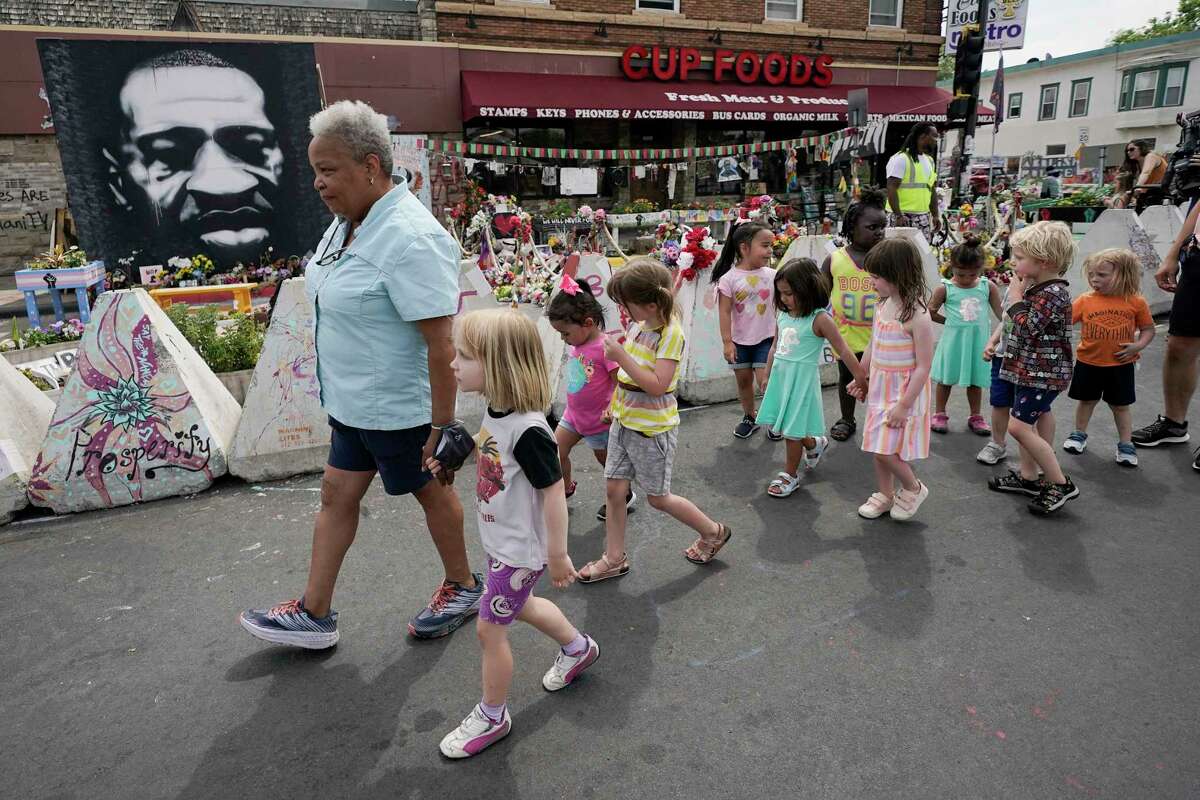 Preschool children visit the site where George Floyd was killed by then Minneapolis Police officer Derek Chauvin, as the kids took a field trip to the memorial, Thursday, June 24, 2021, in Minneapolis. Chauvin is scheduled to be sentenced Friday.