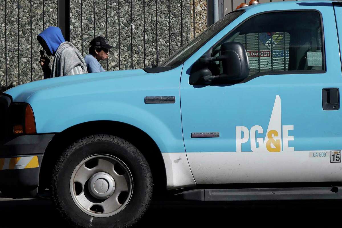 Two PG&E employees robbed in the Oakland hills, police say. People walk behind a Pacific Gas and Electric Co. truck in San Francisco, Calif.